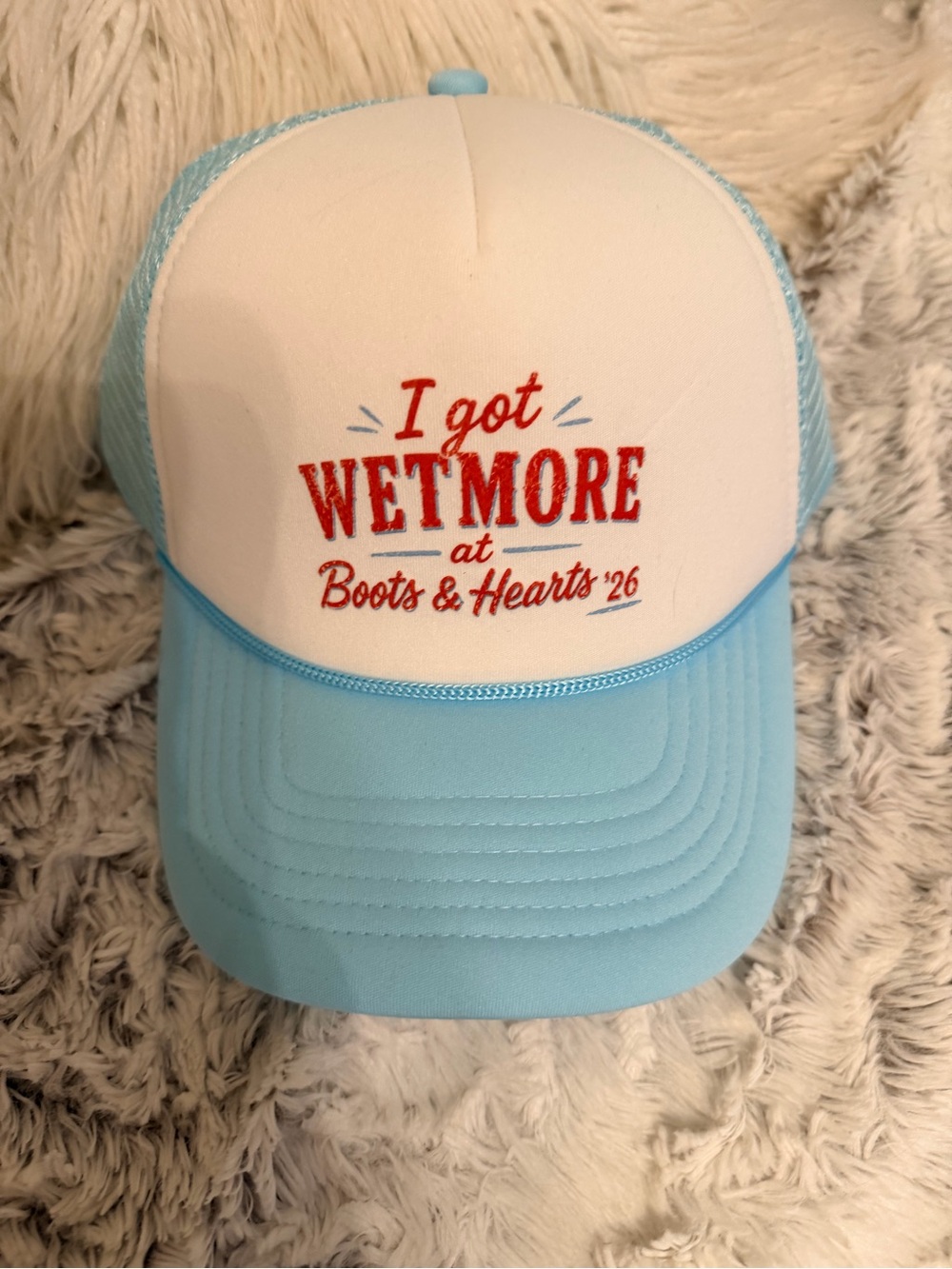 Blue and white trucker hat with embroidered text